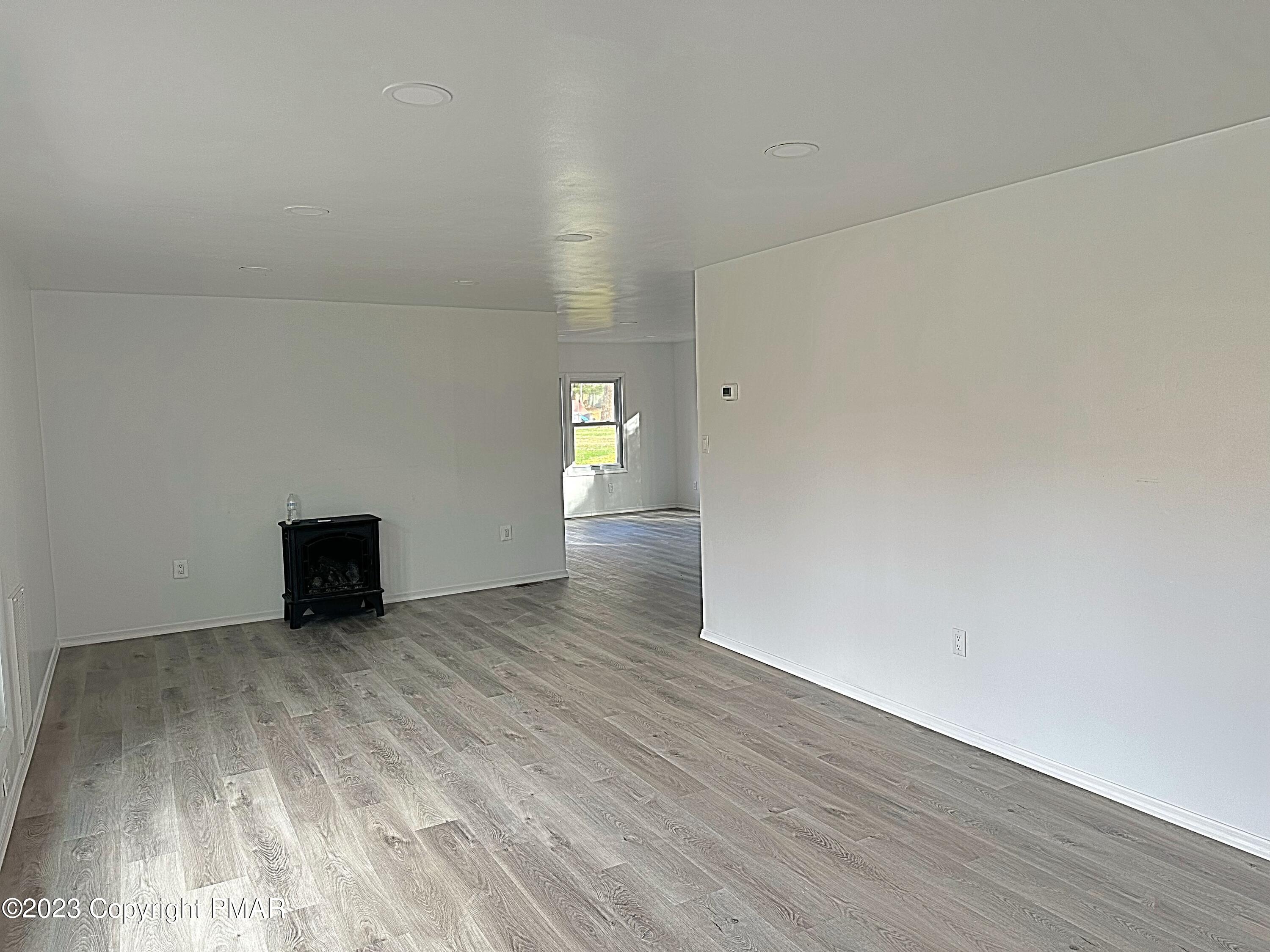 350 Mountain Road Albrightsville, PA 18210 - Photo 4 of 23 a view of an empty room with wooden floor and a window