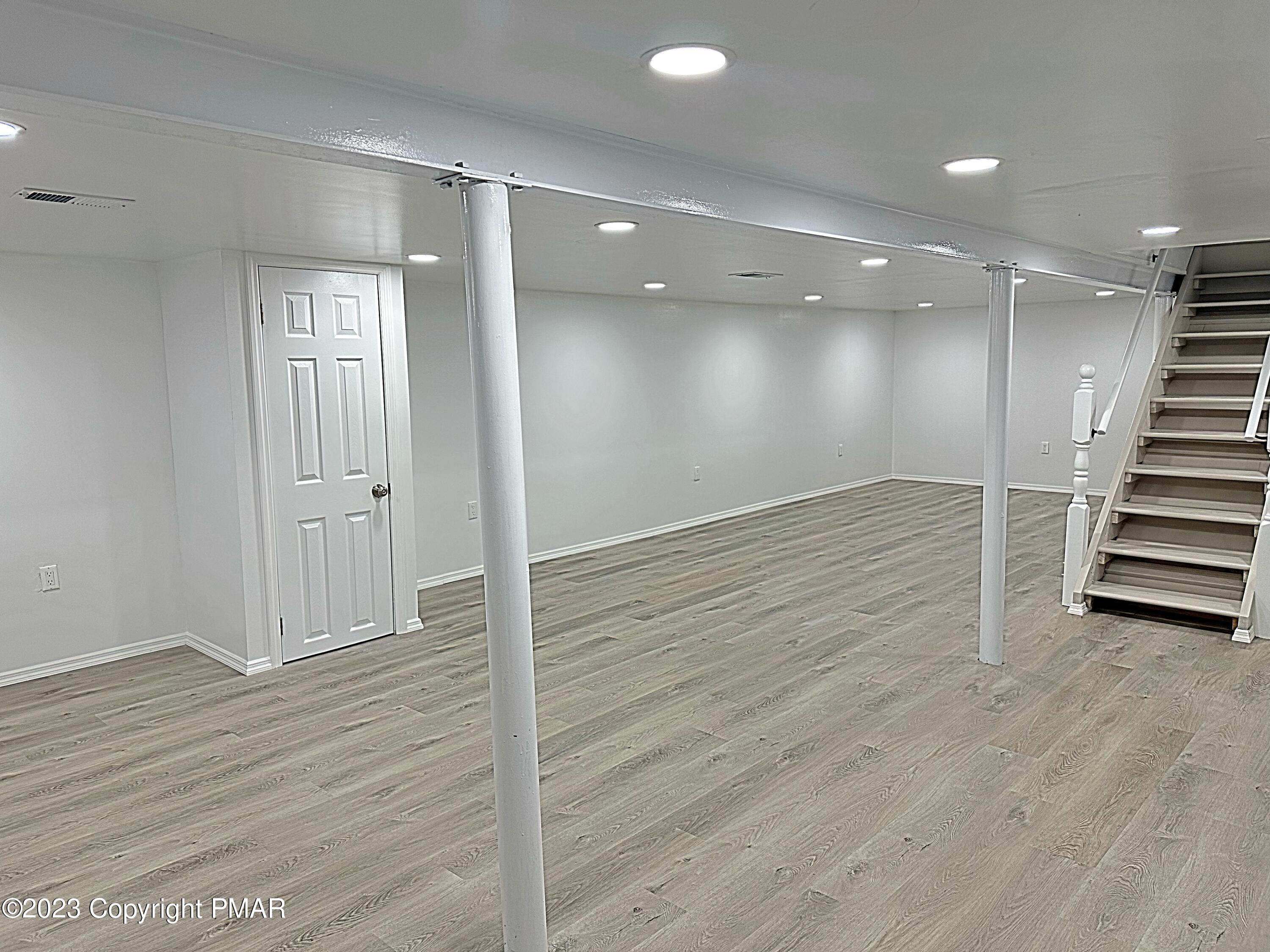 350 Mountain Road Albrightsville, PA 18210 - Photo 5 of 23 an empty room with wooden floor and windows