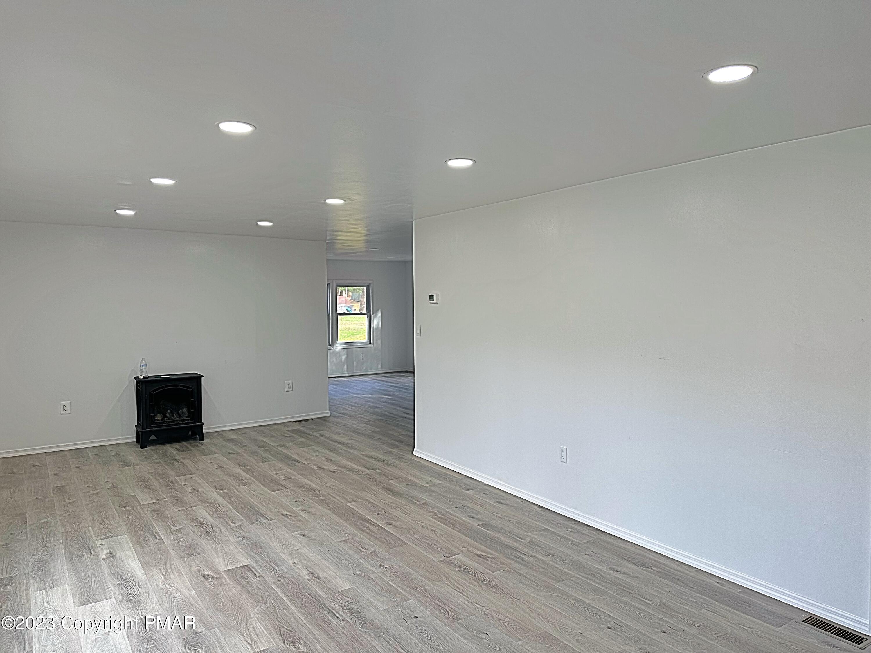 350 Mountain Road Albrightsville, PA 18210 - Photo 7 of 23 a view of an empty room with wooden floor and a window