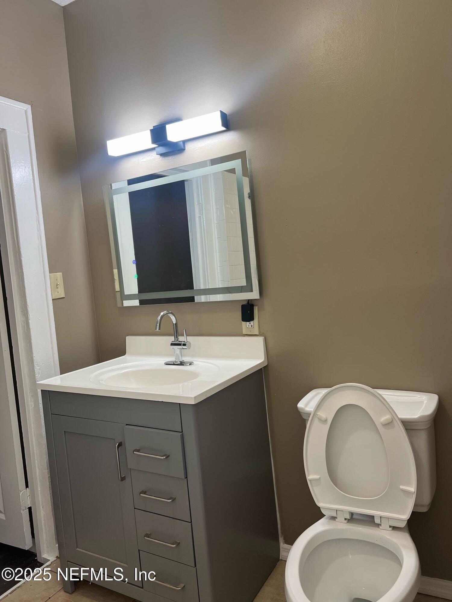 2815 Fleming Street Jacksonville, FL 32254 - Photo 12 of 37 a bathroom with a toilet a sink and mirror