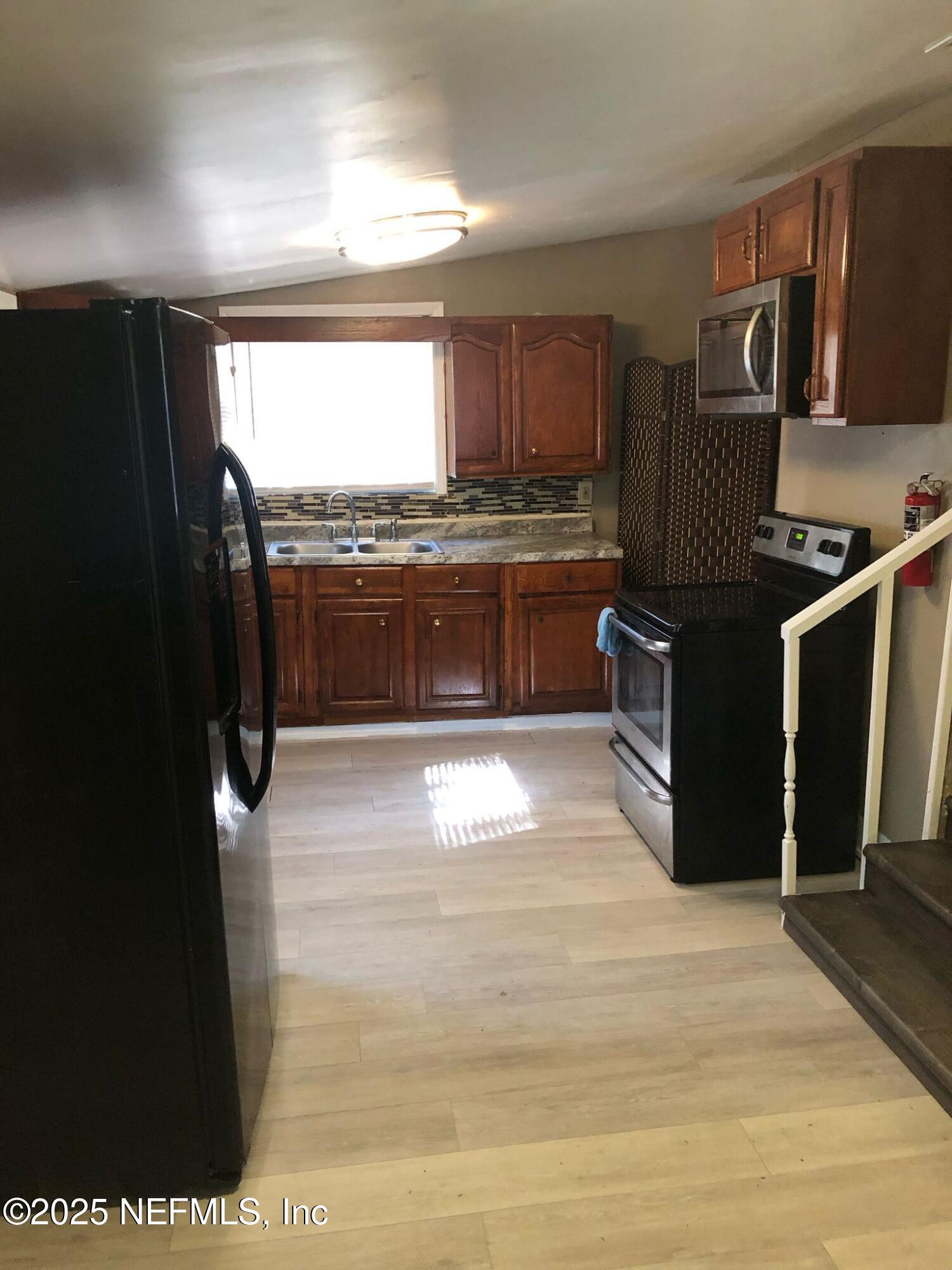 2815 Fleming Street Jacksonville, FL 32254 - Photo 24 of 37 a kitchen with granite countertop a stove and a refrigerator