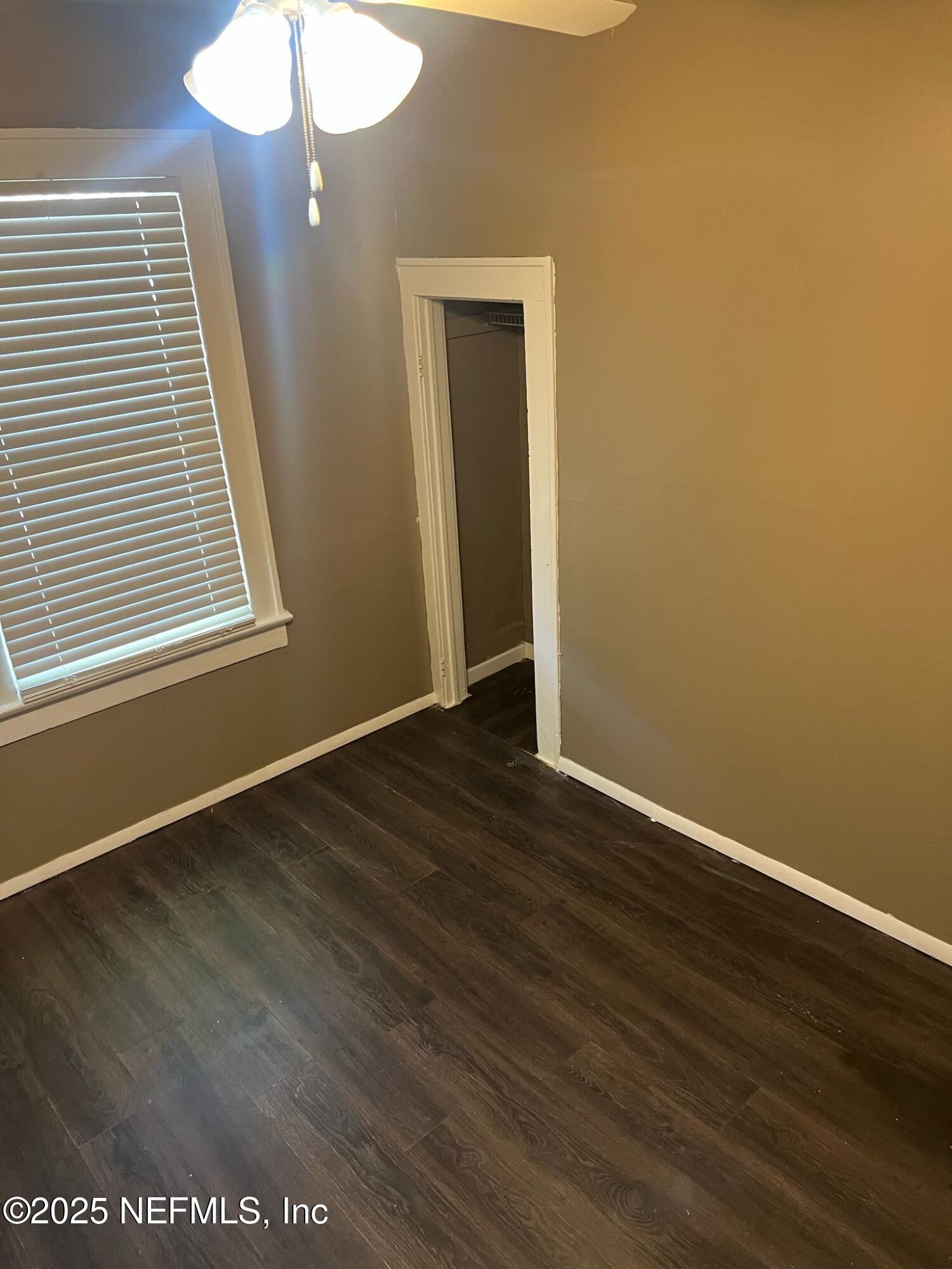 2815 Fleming Street Jacksonville, FL 32254 - Photo 4 of 37 an empty room with wooden floor and windows