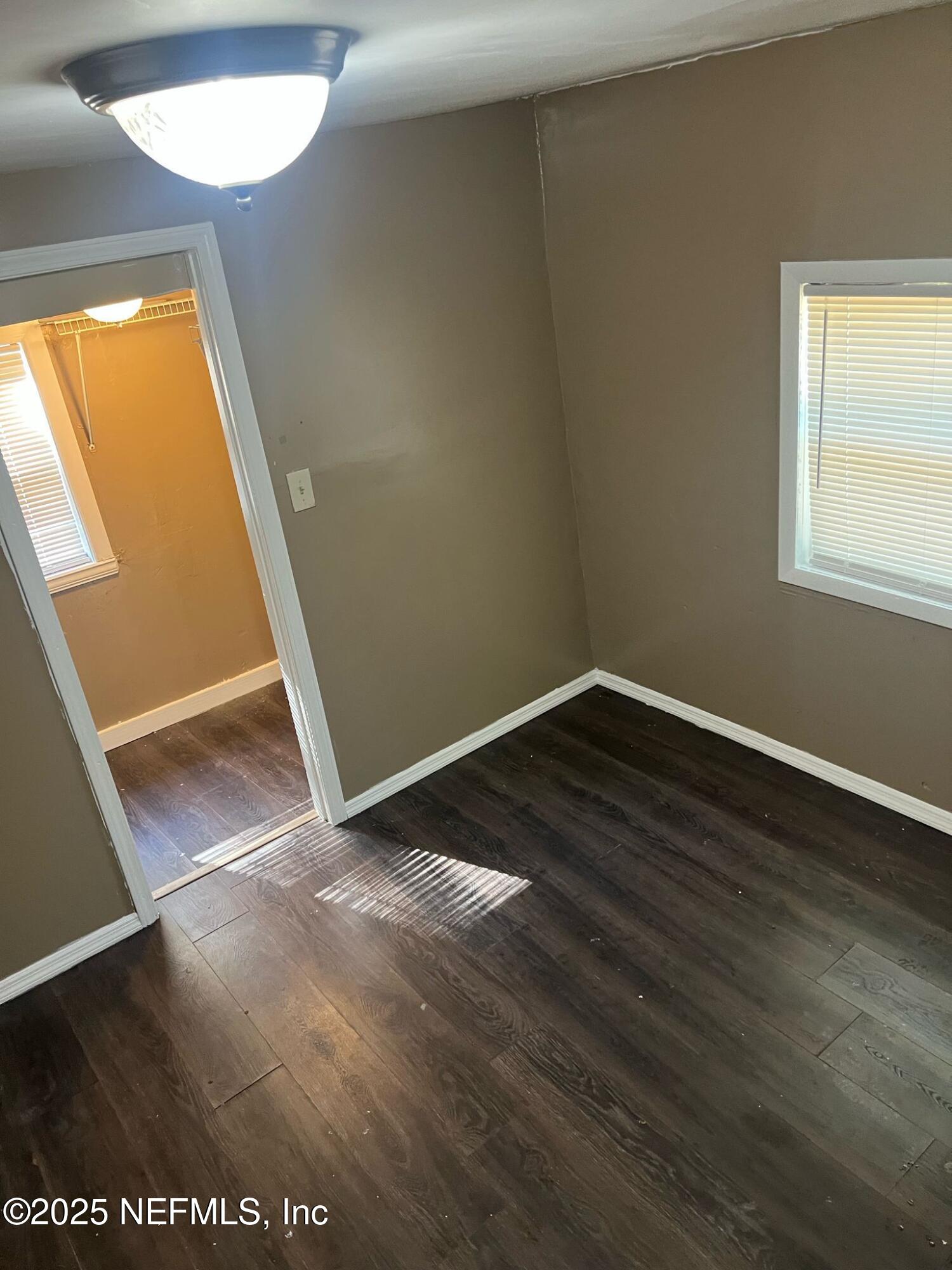 2815 Fleming Street Jacksonville, FL 32254 - Photo 6 of 37 an empty room with wooden floor and windows