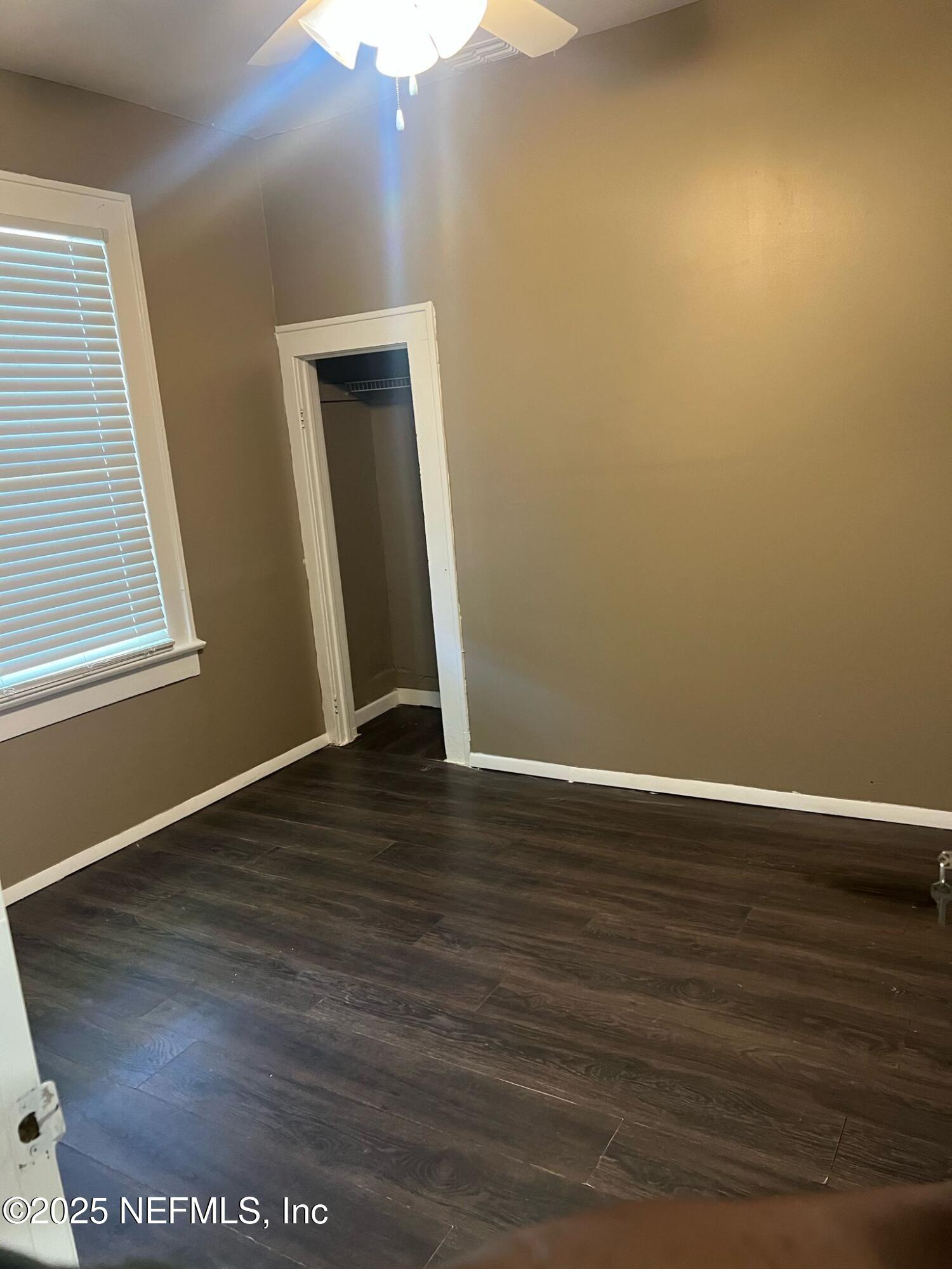 2815 Fleming Street Jacksonville, FL 32254 - Photo 8 of 37 a view of an empty room with wooden floor and a window
