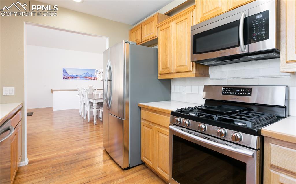 840 West Kelly Road Woodland Park, CO 80863 - Photo 11 of 37 a kitchen with stainless steel appliances a stove a microwave and cabinets
