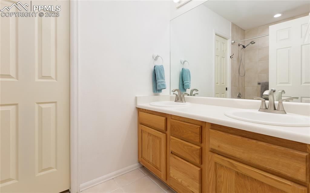 840 West Kelly Road Woodland Park, CO 80863 - Photo 14 of 37 a bathroom with a double vanity sink and a mirror