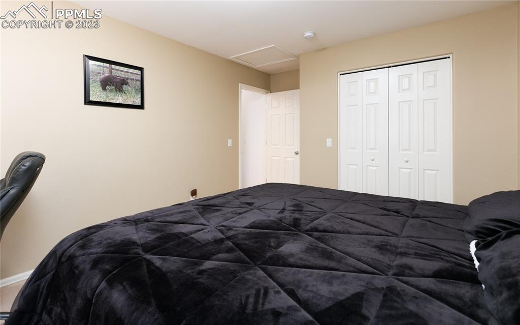 840 West Kelly Road Woodland Park, CO 80863 - Photo 20 of 37 a bedroom with a bed and a painting on the wall