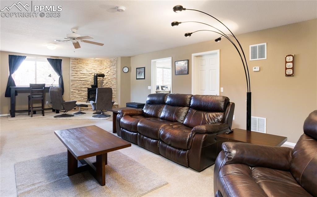 840 West Kelly Road Woodland Park, CO 80863 - Photo 25 of 37 a living room with furniture and a mirror