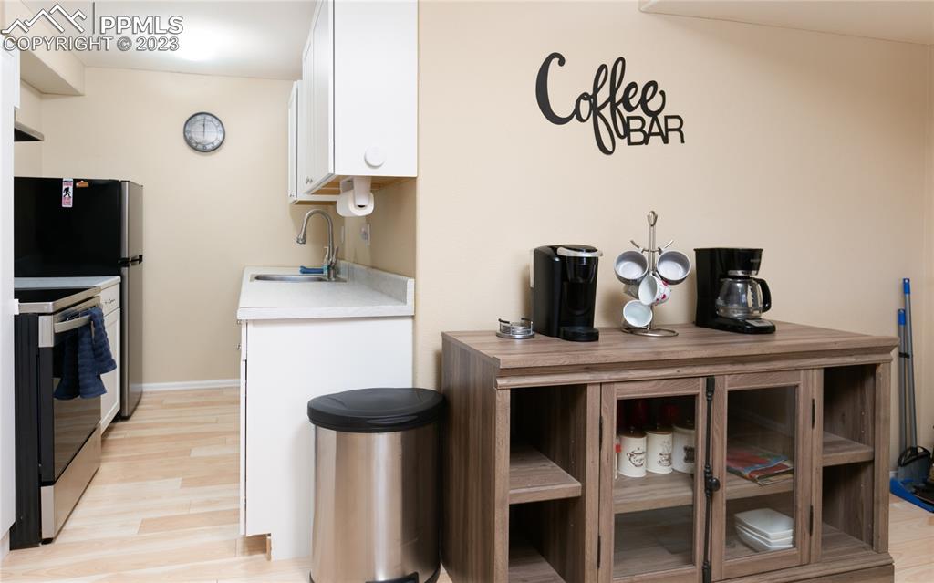 840 West Kelly Road Woodland Park, CO 80863 - Photo 28 of 37 a kitchen with stainless steel appliances a table chairs in it and wooden floors