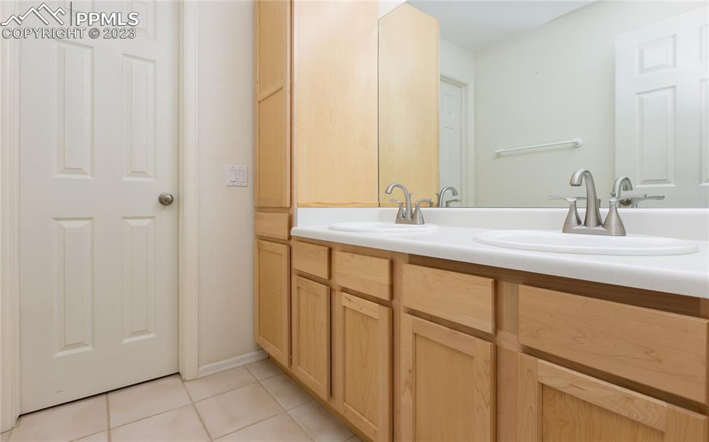 840 West Kelly Road Woodland Park, CO 80863 - Photo 30 of 37 a bathroom with a double vanity sink and a mirror