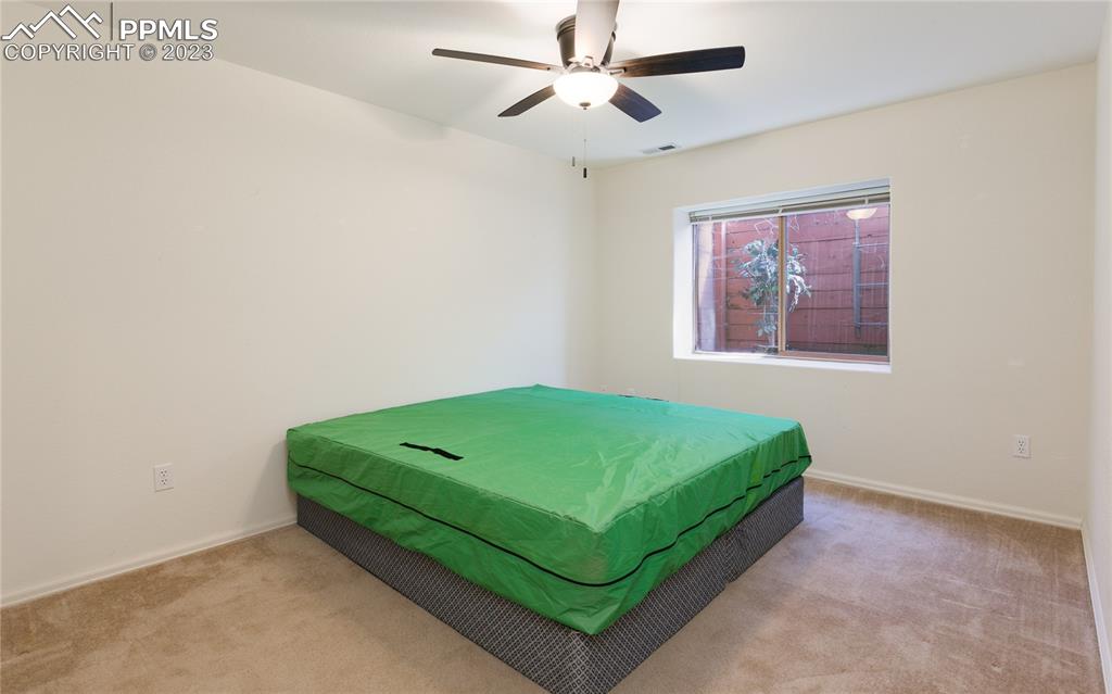 840 West Kelly Road Woodland Park, CO 80863 - Photo 32 of 37 a room with a bed and a painting on the wall