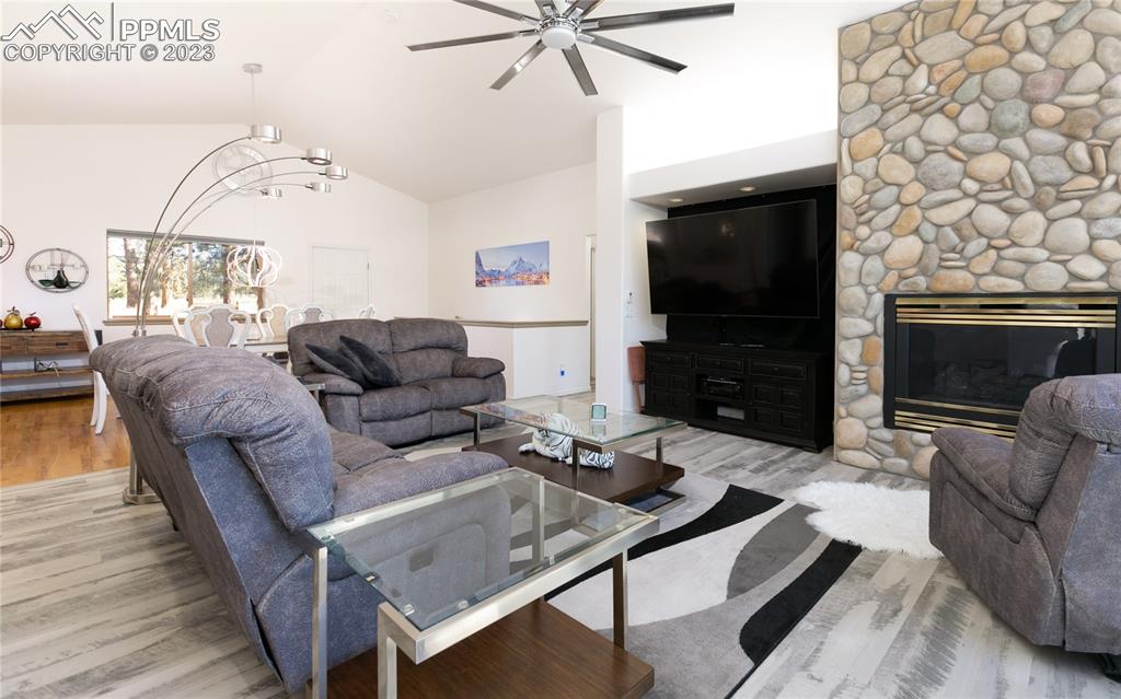 840 West Kelly Road Woodland Park, CO 80863 - Photo 7 of 37 a living room with furniture a flat screen tv and a fireplace