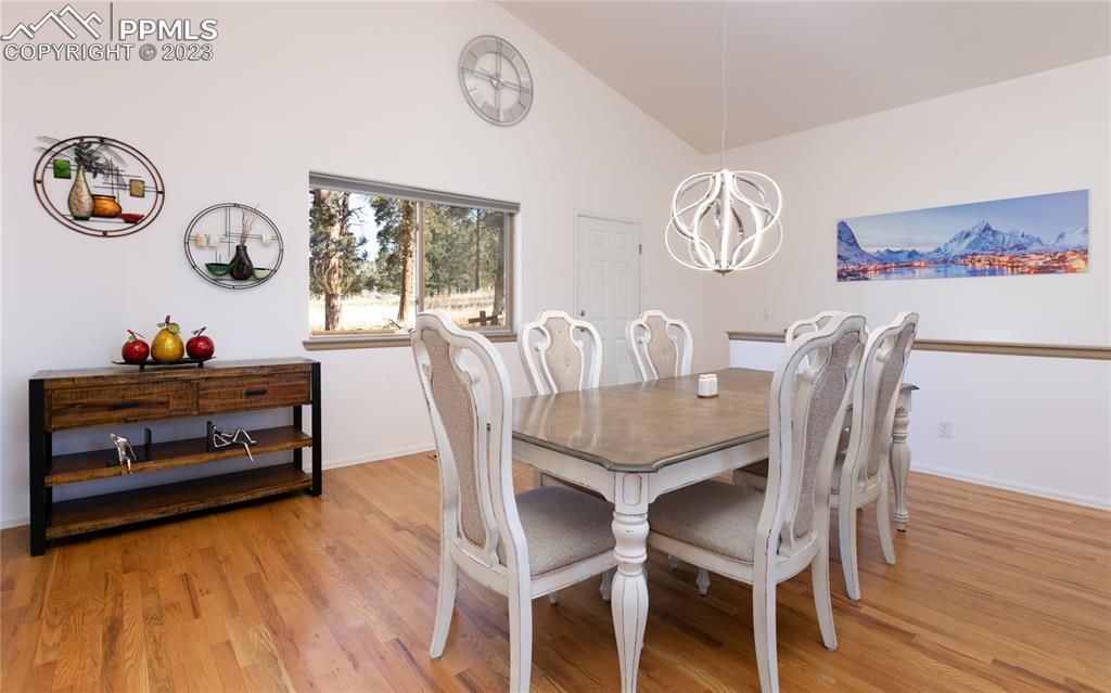 840 West Kelly Road Woodland Park, CO 80863 - Photo 8 of 37 a dining room with furniture a rug and wooden floor