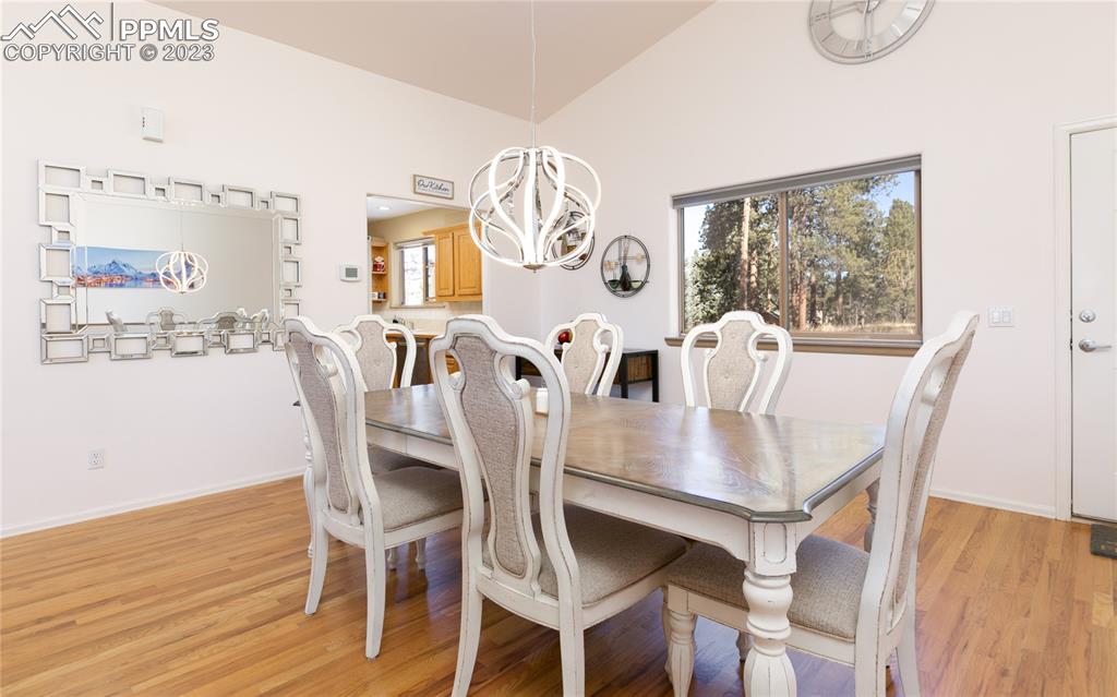 840 West Kelly Road Woodland Park, CO 80863 - Photo 9 of 37 a view of a dining room with furniture and wooden floor