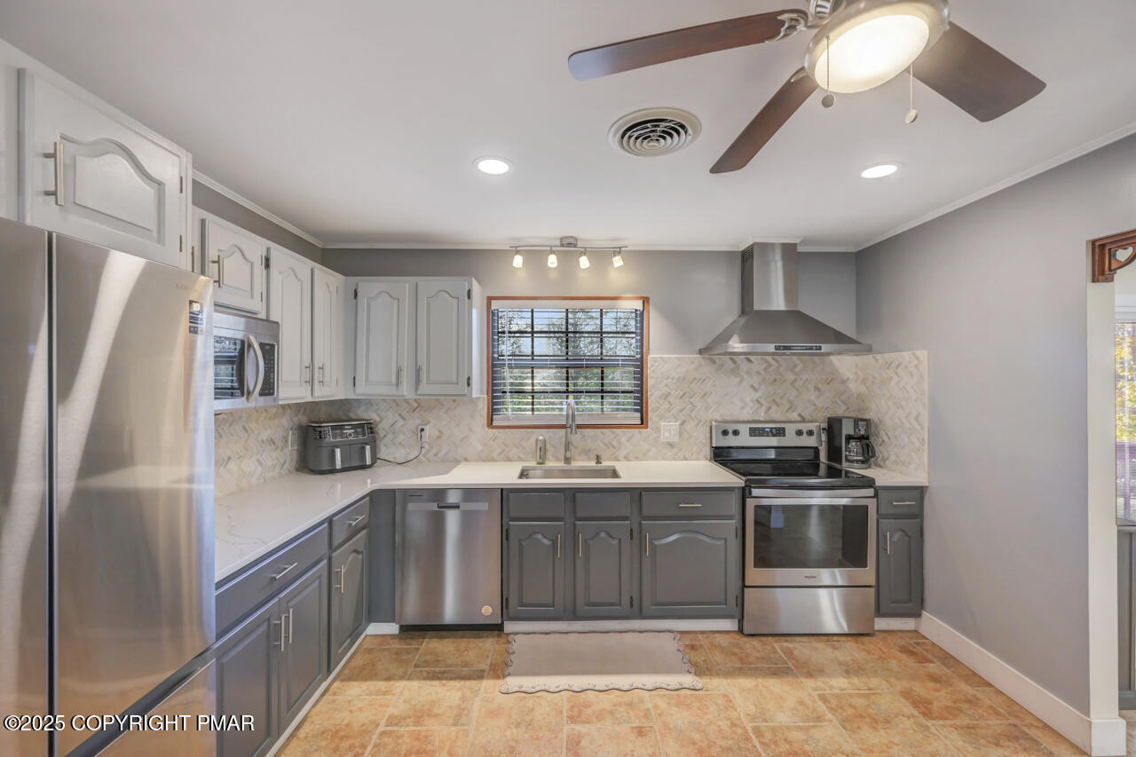 9 Gap View Heights Road East Stroudsburg, PA 18301 - Photo 19 of 57 a kitchen with stainless steel appliances granite countertop a sink a stove a refrigerator cabinets and a window