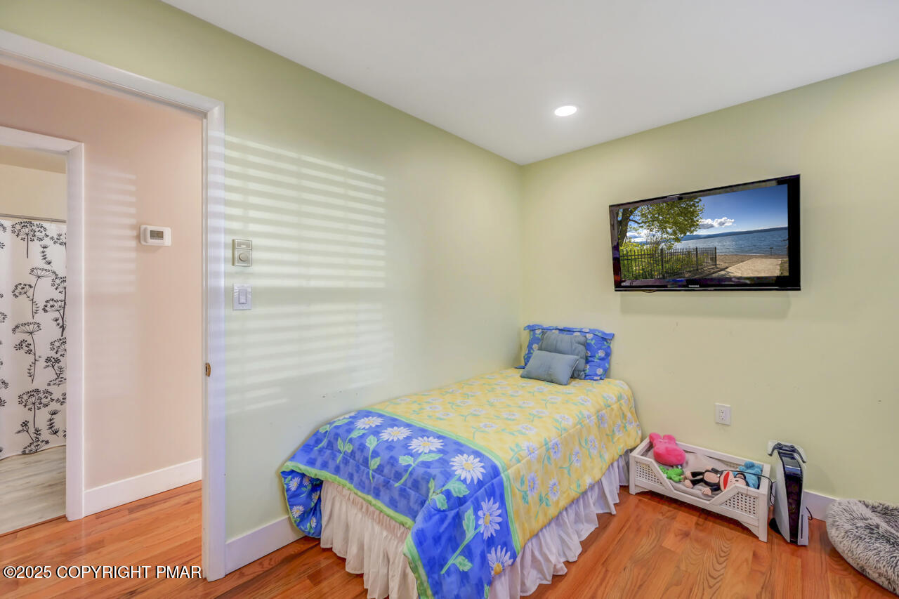 9 Gap View Heights Road East Stroudsburg, PA 18301 - Photo 40 of 57 a bedroom with a bed and a flat screen tv