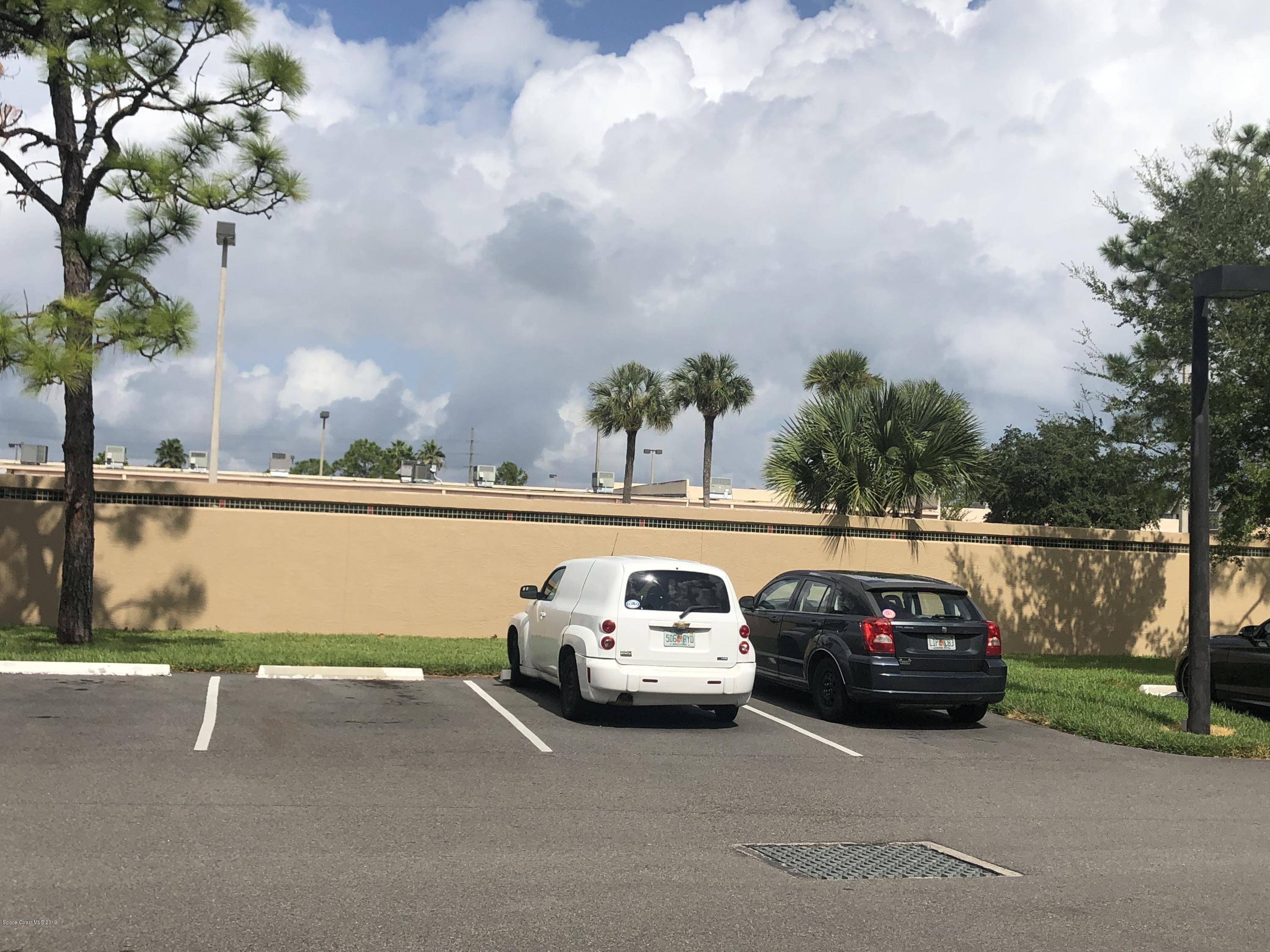 7667 North Wickham Road, Unit 915 Melbourne, FL 32940 - Photo 12 of 12 a car parked on the side of the road