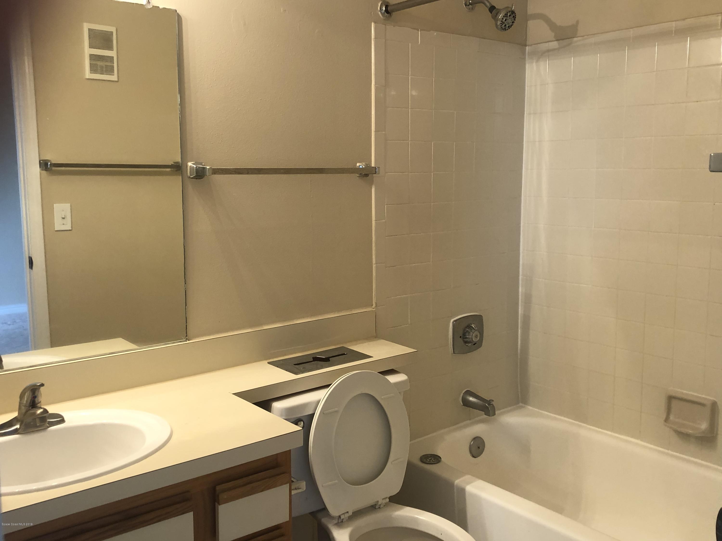 7667 North Wickham Road, Unit 915 Melbourne, FL 32940 - Photo 5 of 12 a bathroom with a sink and a tub