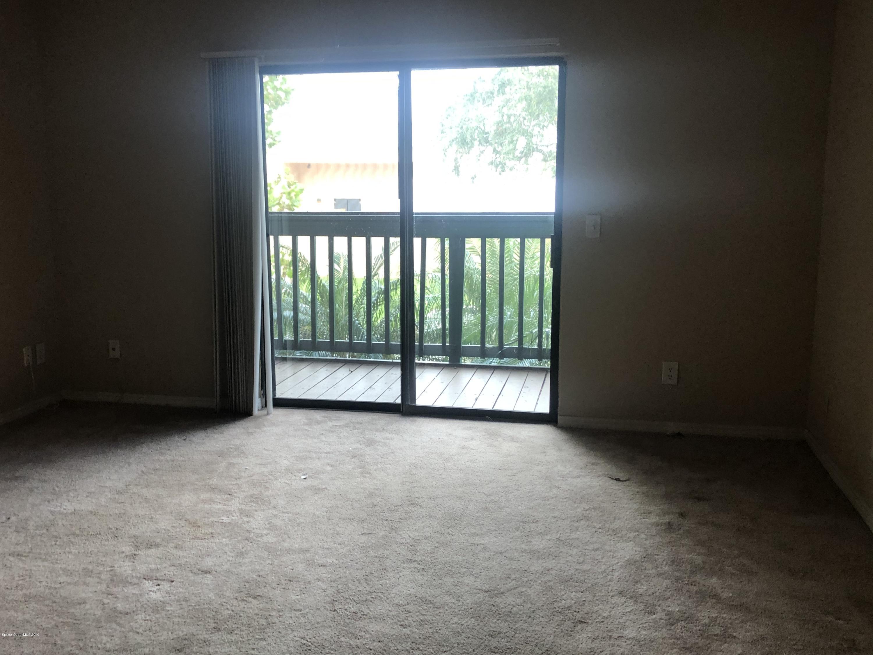 7667 North Wickham Road, Unit 915 Melbourne, FL 32940 - Photo 7 of 12 a view of an empty room with a balcony