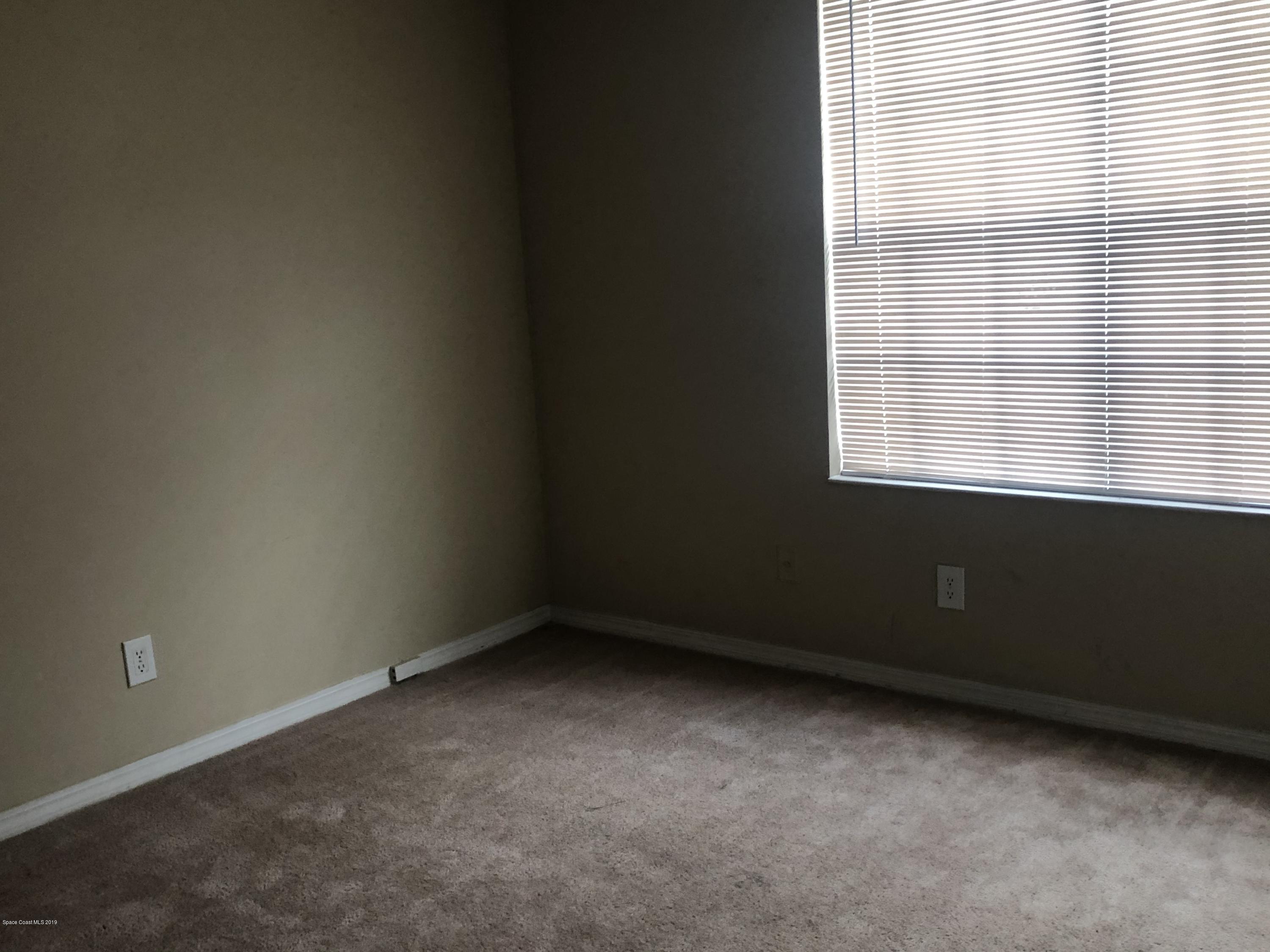 7667 North Wickham Road, Unit 915 Melbourne, FL 32940 - Photo 8 of 12 an empty room with a window