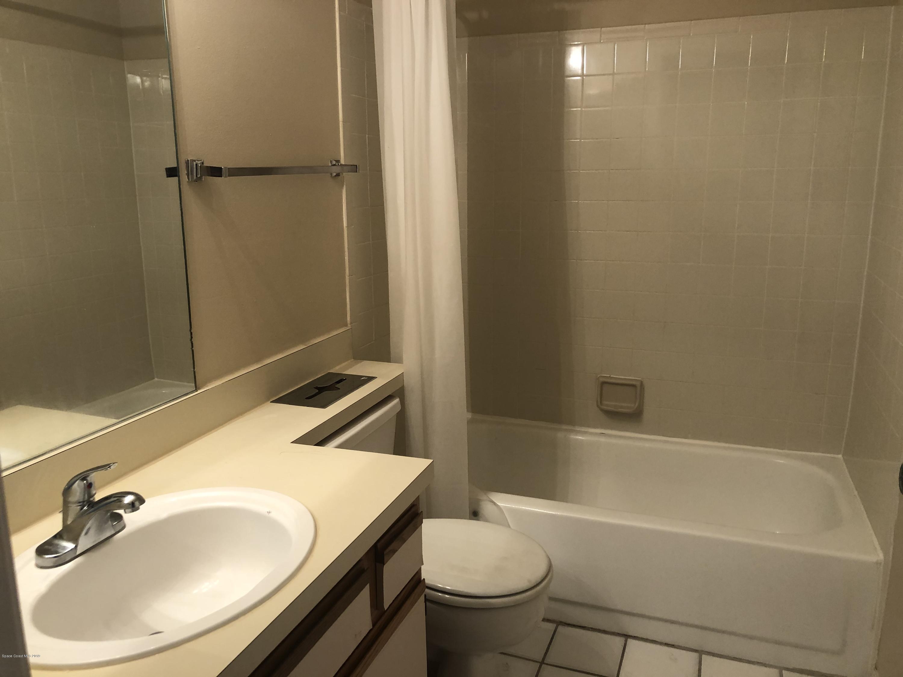 7667 North Wickham Road, Unit 915 Melbourne, FL 32940 - Photo 9 of 12 a bathroom with a sink toilet and shower