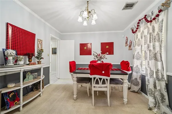 a view of a dining room with furniture and chandelier