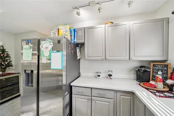 a kitchen with stainless steel appliances granite countertop a refrigerator and a sink