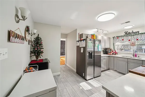 a kitchen with refrigerator and window