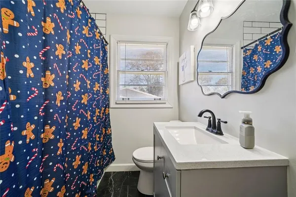 a bathroom with a sink mirror vanity and toilet