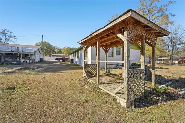 a view of a house with a yard and sitting area