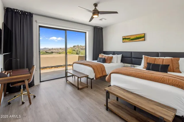 a bedroom with bed and a large window