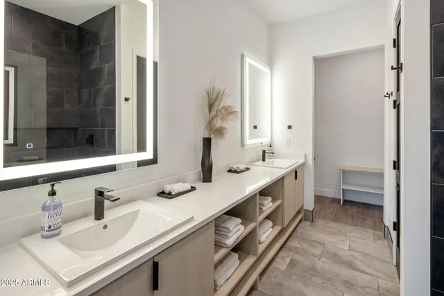 a bathroom with a sink a shower and a mirror