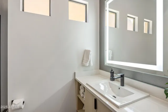 a bathroom with a sink and a mirror