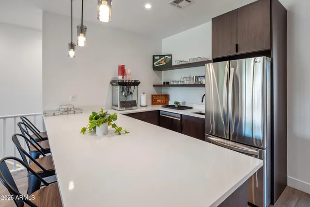 a view of a patio with table and chairs potted plants and a palm tree