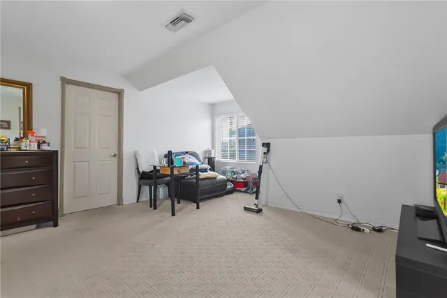 a view of a livingroom with furniture and a window