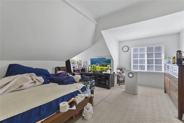 a bedroom with a bed and a tv