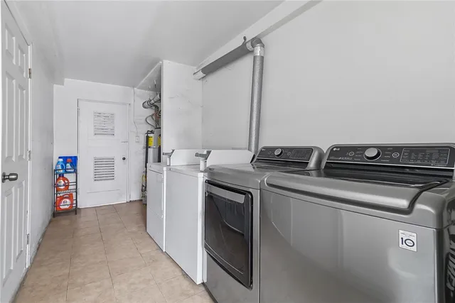 a view of a kitchen with a sink and dishwasher a refrigerator with wooden floor