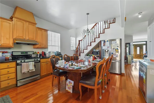 a dining room with furniture and wooden floor