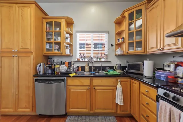 a kitchen with stainless steel appliances granite countertop a sink and cabinets
