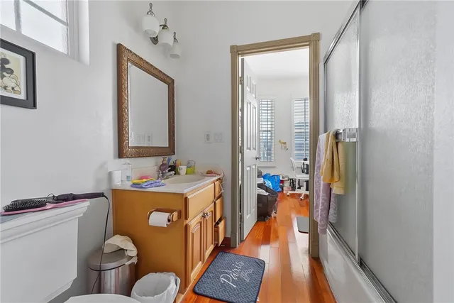 a bathroom with a sink mirror vanity and toilet