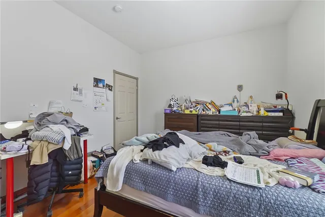 a bed room with a bed and wooden floor