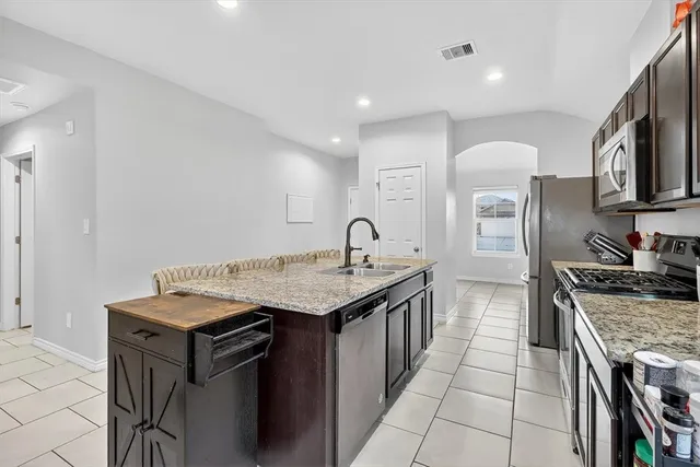 a kitchen that has a sink and a stove in it