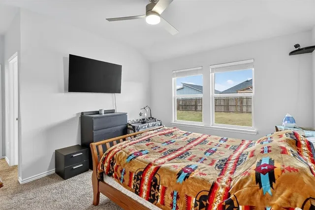 a bedroom with a bed and a flat tv screen