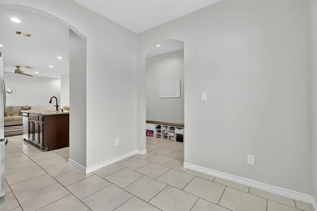 a view of kitchen with furniture and electronic appliances