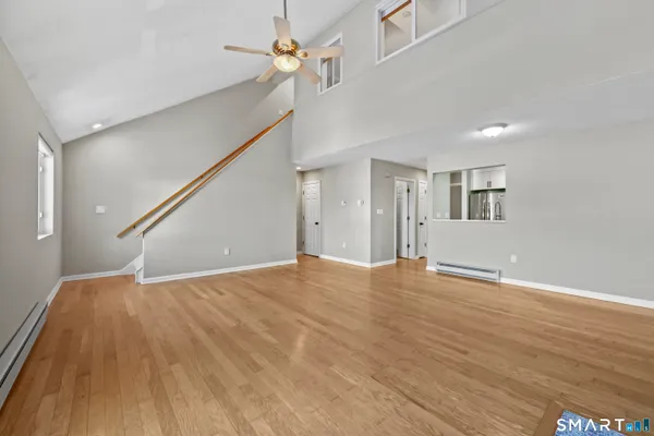 a view of an empty room with wooden floor