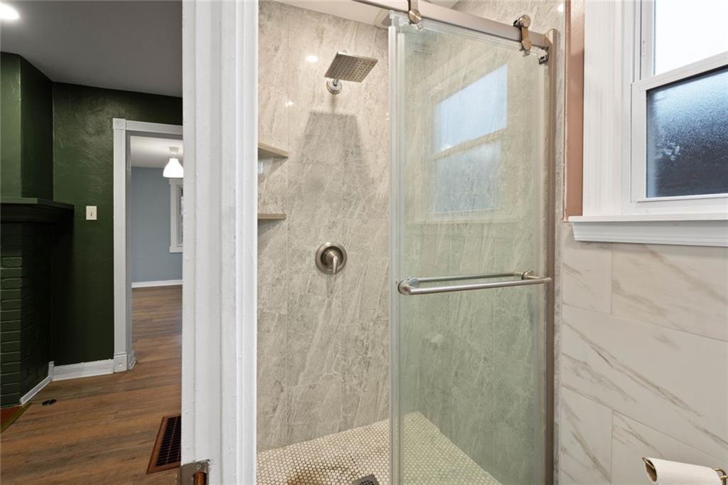7129 Michigan Street Pittsburgh, PA 15218 - Photo 12 of 25 a bathroom with a glass shower door