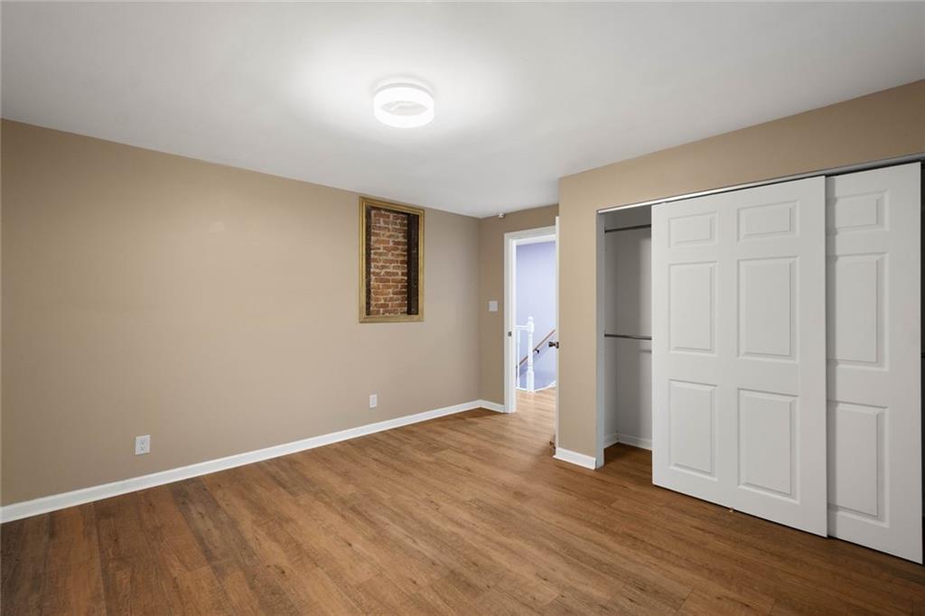 7129 Michigan Street Pittsburgh, PA 15218 - Photo 15 of 25 a view of an empty room with wooden floor