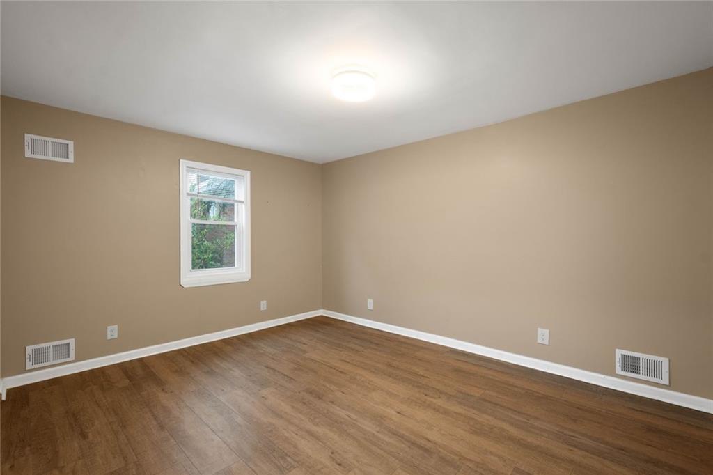 7129 Michigan Street Pittsburgh, PA 15218 - Photo 16 of 25 a view of an empty room with wooden floor and a window