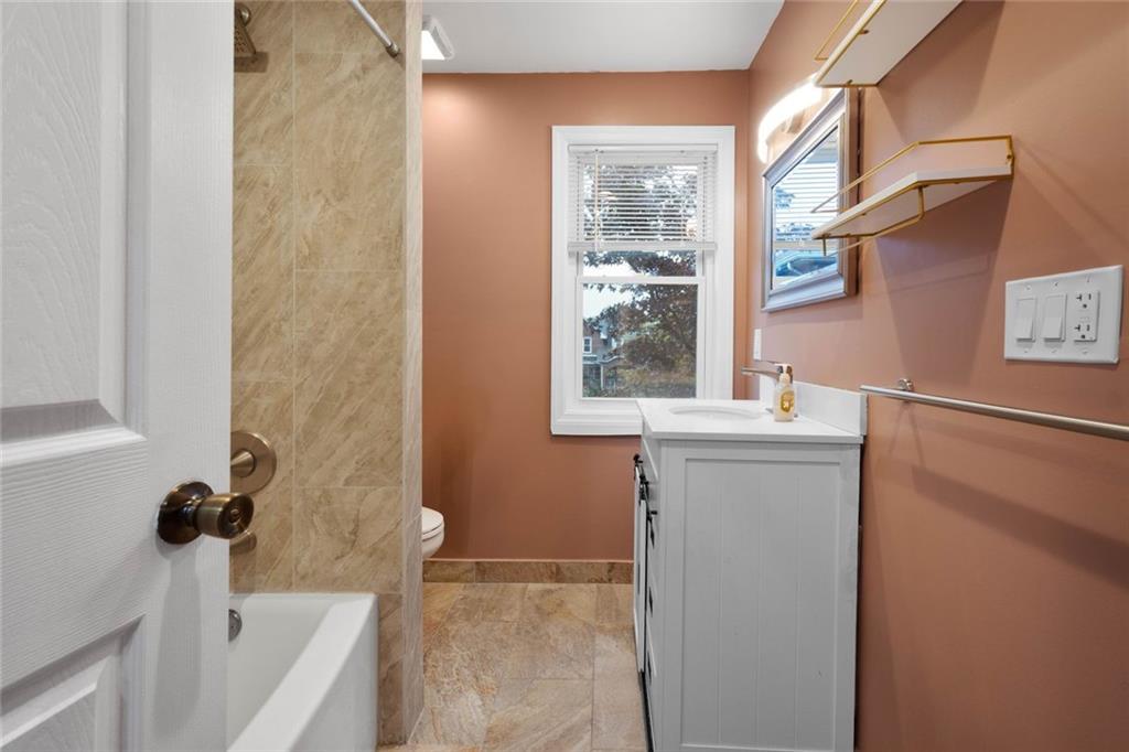 7129 Michigan Street Pittsburgh, PA 15218 - Photo 19 of 25 a bathroom with a sink and a tub