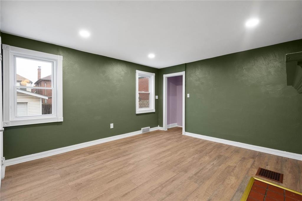 7129 Michigan Street Pittsburgh, PA 15218 - Photo 3 of 25 a view of an empty room with wooden floor and a window